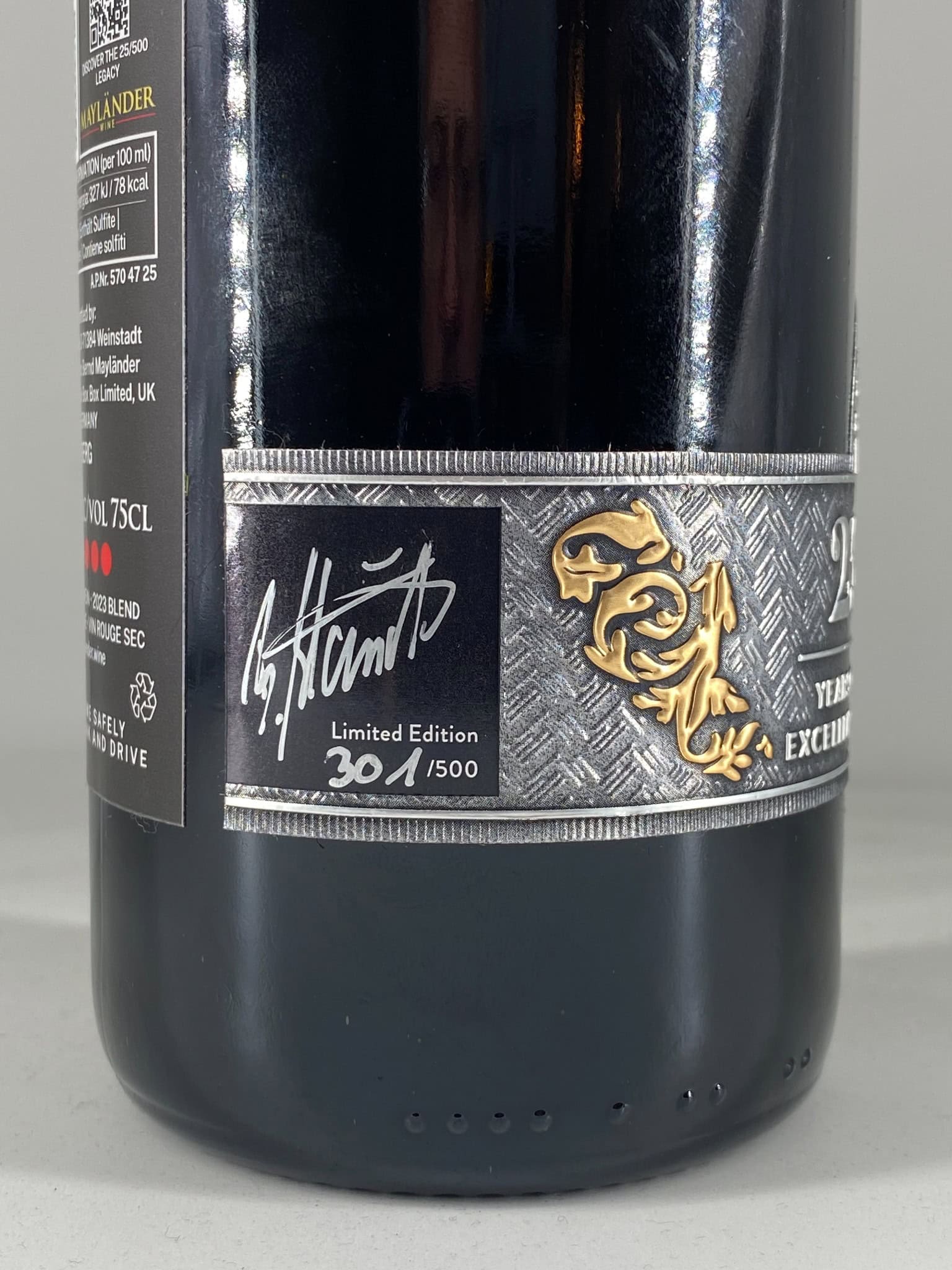 Limited edition Mayländer wine bottle with signature and gold dragon emblem.